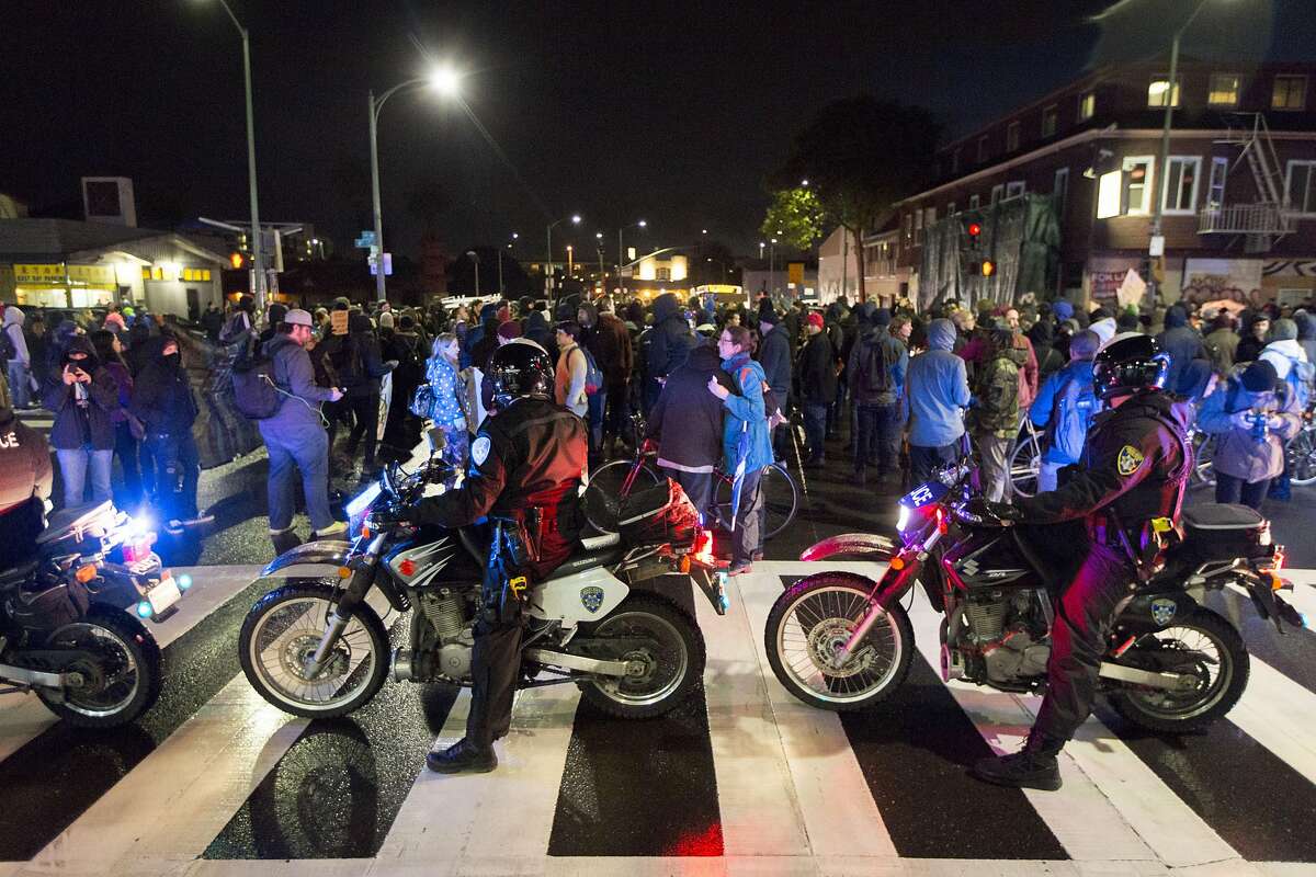 Police block a street as an anti-Trump rally marches around downtown Oakland, Friday, Jan. 20, 2017 in Oakland, CA.