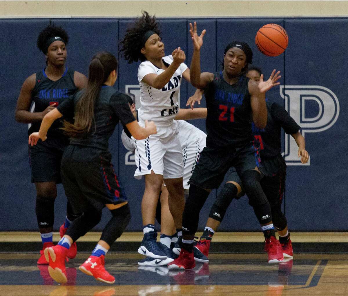 Oak Ridge's Alecia Whyte (21) tries to locate a rebound after College Park's Jasmine Handy (1) is stripped of the ball during the third quarter of a District 16-6A high school girls basketball game at College Park High School Friday, Jan. 20, 2017, in The Woodlands. Oak Ridge defeated College Park 56-39.