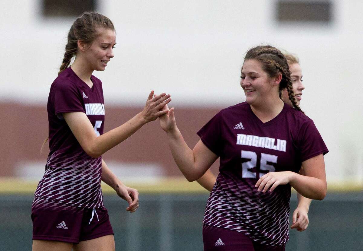 Magnolia midfielder Breane Podhaisky (5), left, celebrates with defenseman Jaycee Fraser (25) after scoring a goal against Angleton during the first period of a high school girls soccer match in the Texans Drive Tournament at Porter High School Friday, Jan. 20, 2017, in Porter.