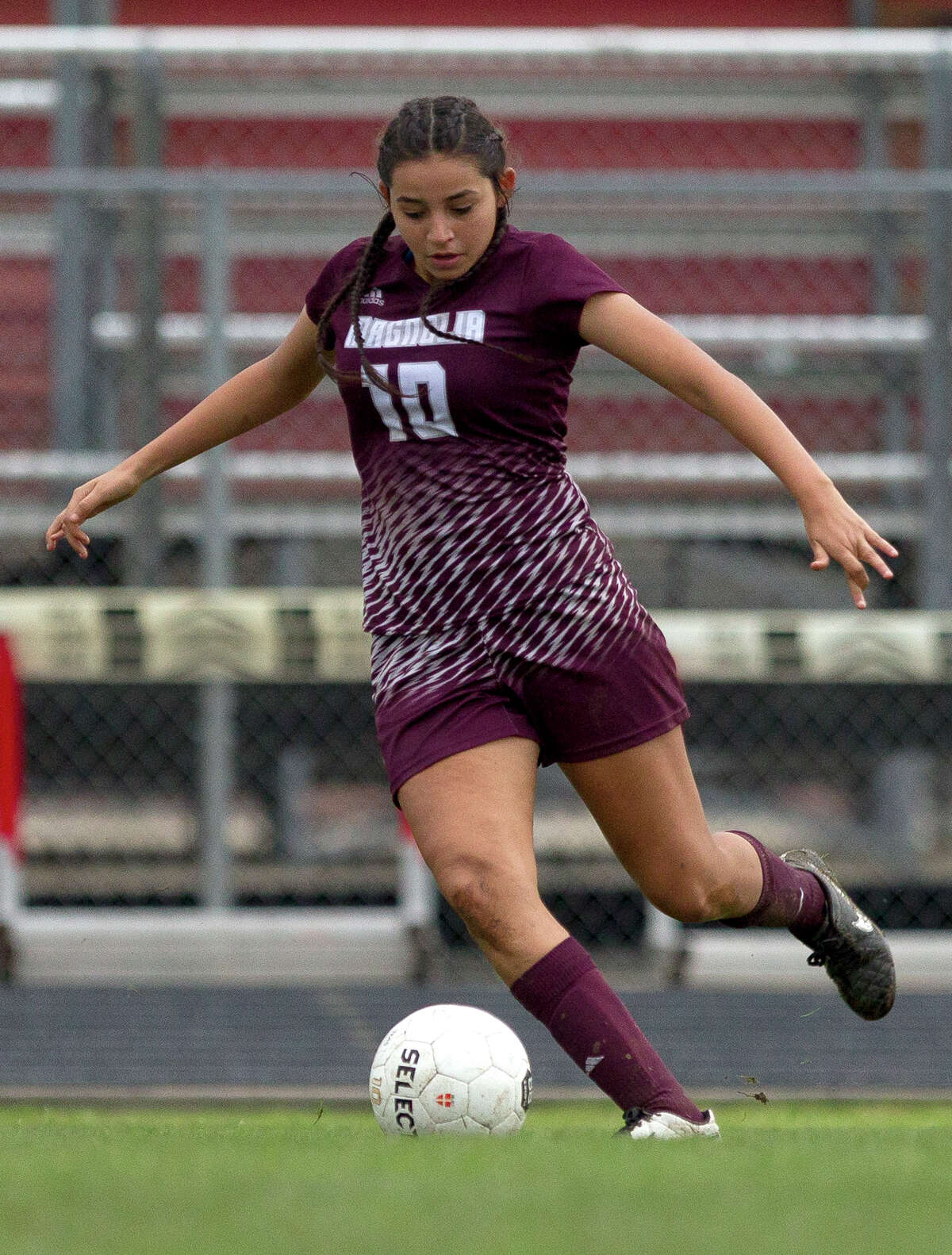 Magnolia forward Vanessa Aragon (10) makes a pass during the first period of a high school girls soccer match in the Texans Drive Tournament at Porter High School Friday, Jan. 20, 2017, in Porter.