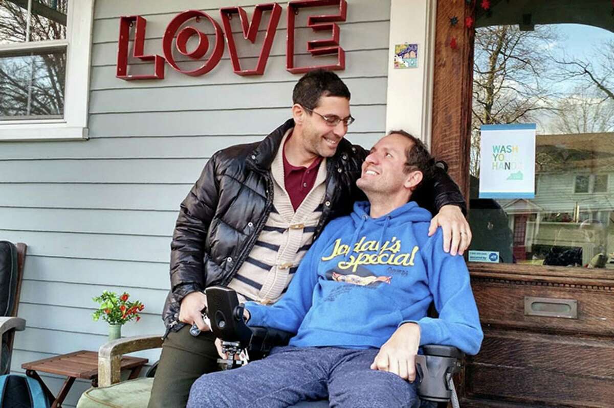 Dave Adox, right, and his husband Danni Michaeli at their home in South Orange, N.J., in fall of 2014. (Courtesy of Evan Bachner)