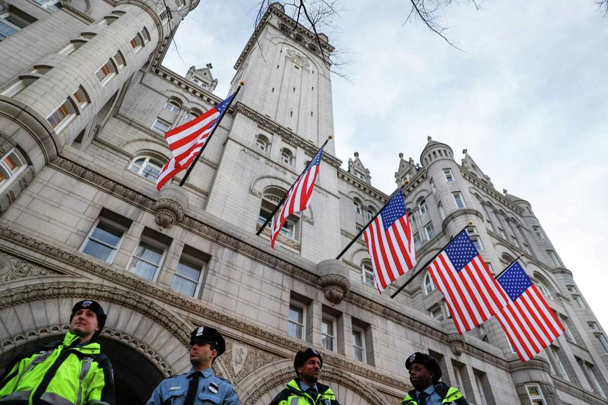 Police guard the Trump International Hotel on Pennsylvania Avenue. Trump's lease prohibits any elected official from benefiting from the property.﻿