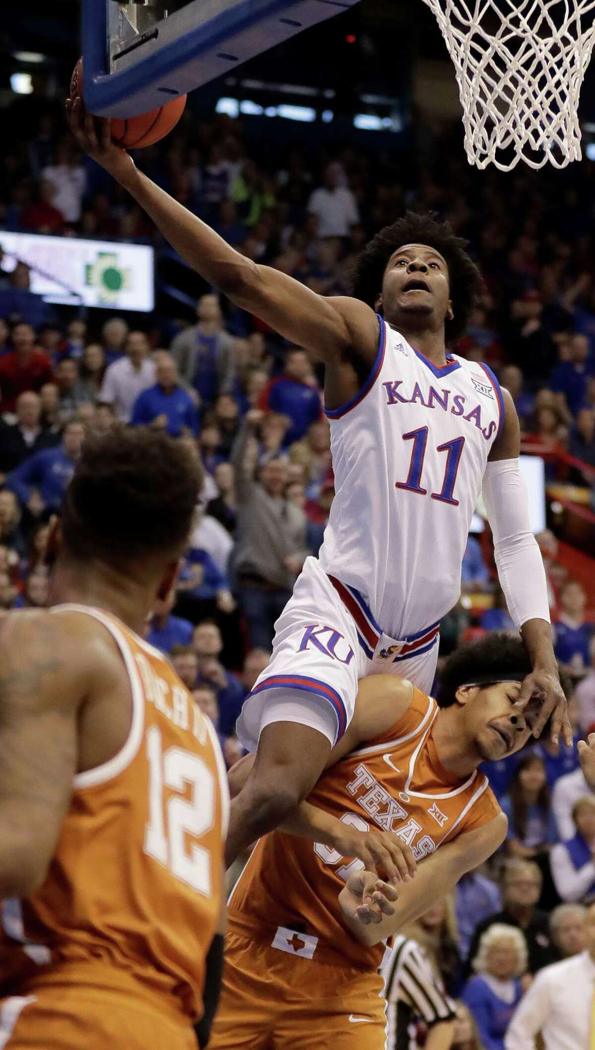 Kansas' Josh Jackson soars over Texas' Jarrett Allen to put up a shot during the first half, helping the Jayhawks jump out to a 41-33 lead at the break.