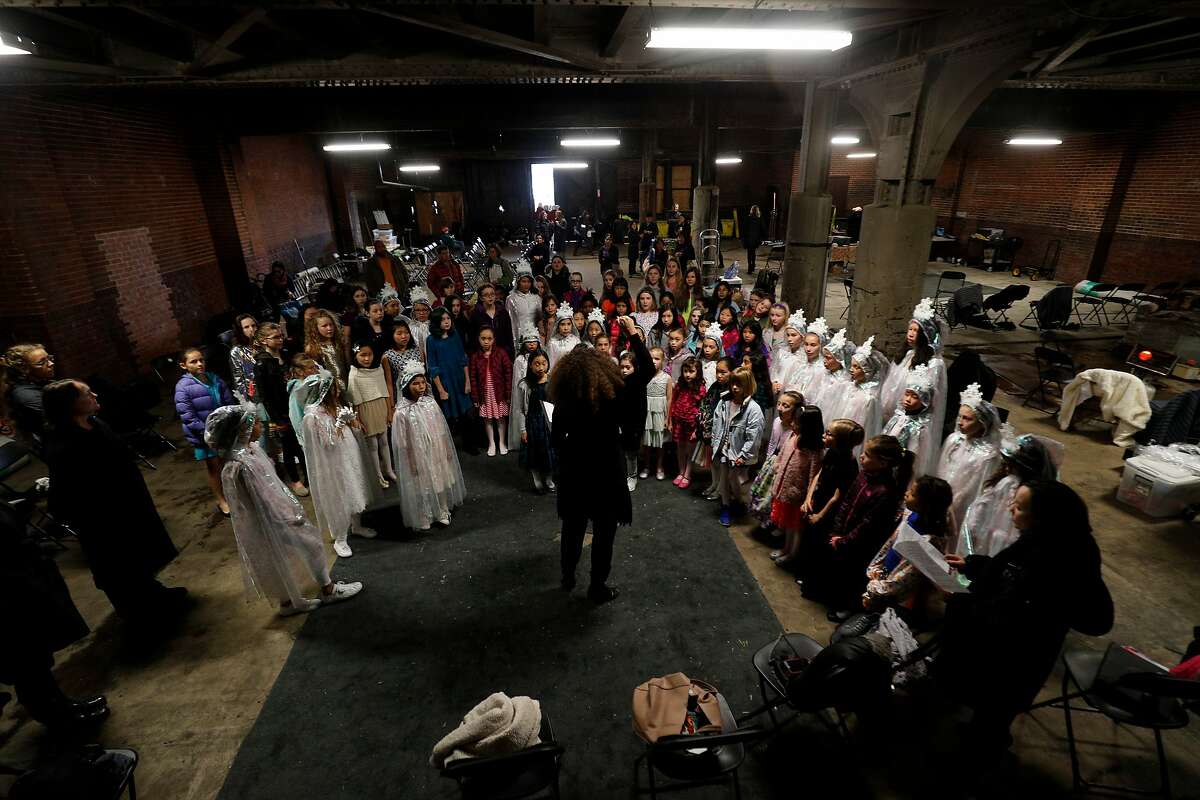 SF Girls Chorus warms up off set for their their performance in a television opera called "Vireo." at the 16th Street Station on Saturday, Jan. 21, 2017 in Oakland, Calif. It's the last episode of a 12-episode season. The whole season will air in early