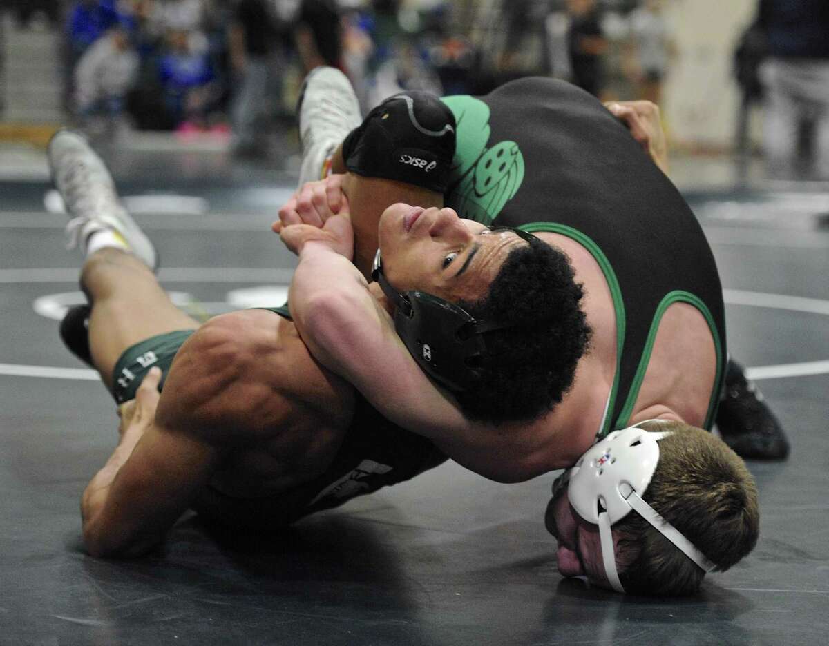 Maloney’s Markeese Thompson, left, and New Milford’s Cameron Berger wrestle in a 160-pound semifinal match Saturday at the New Milford tournament.