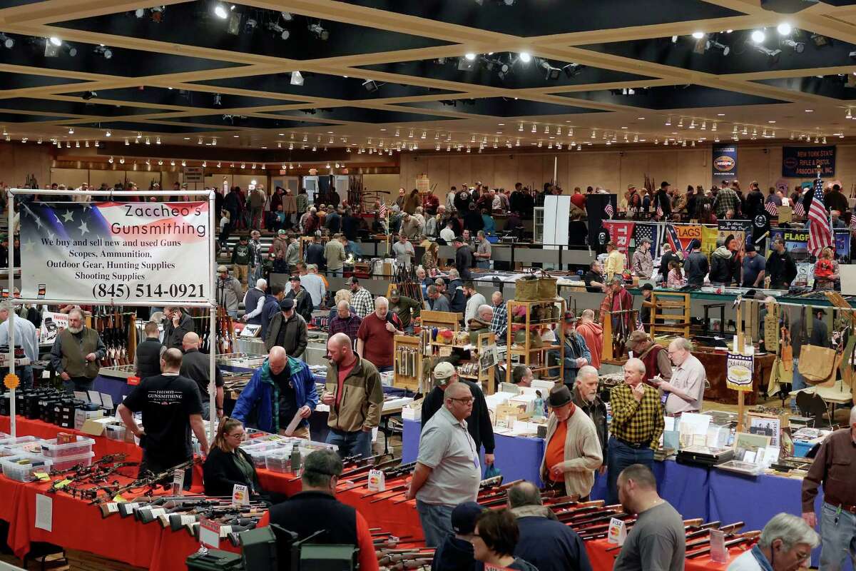 People look over the items at dealer's tables at the New York State Arms Collectors Gun Show at the Empire State Plaza Convention Center on Sunday, Jan. 22, 2017, in Albany, N.Y. The yearly gun show was held on Saturday and Sunday, with 400 dealers from around the northeast. The group also holds a larger yearly gun show in April at the New York State Fair Grounds in Syracuse. (Paul Buckowski / Times Union)