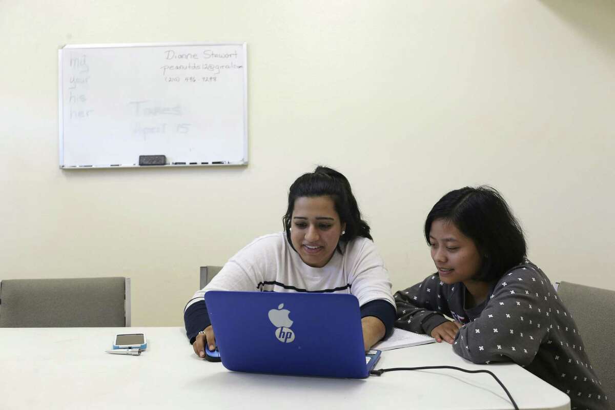 Volunteer Kiran Lalani, 20, left, helps Lun Nuam, 23, with a history assignment during and English as a Second Language class at The Center for Refugee Services, Thursday, Jan. 19, 2017. Nuam is an immigrant from Myanmar and has been in the U.S. three years.