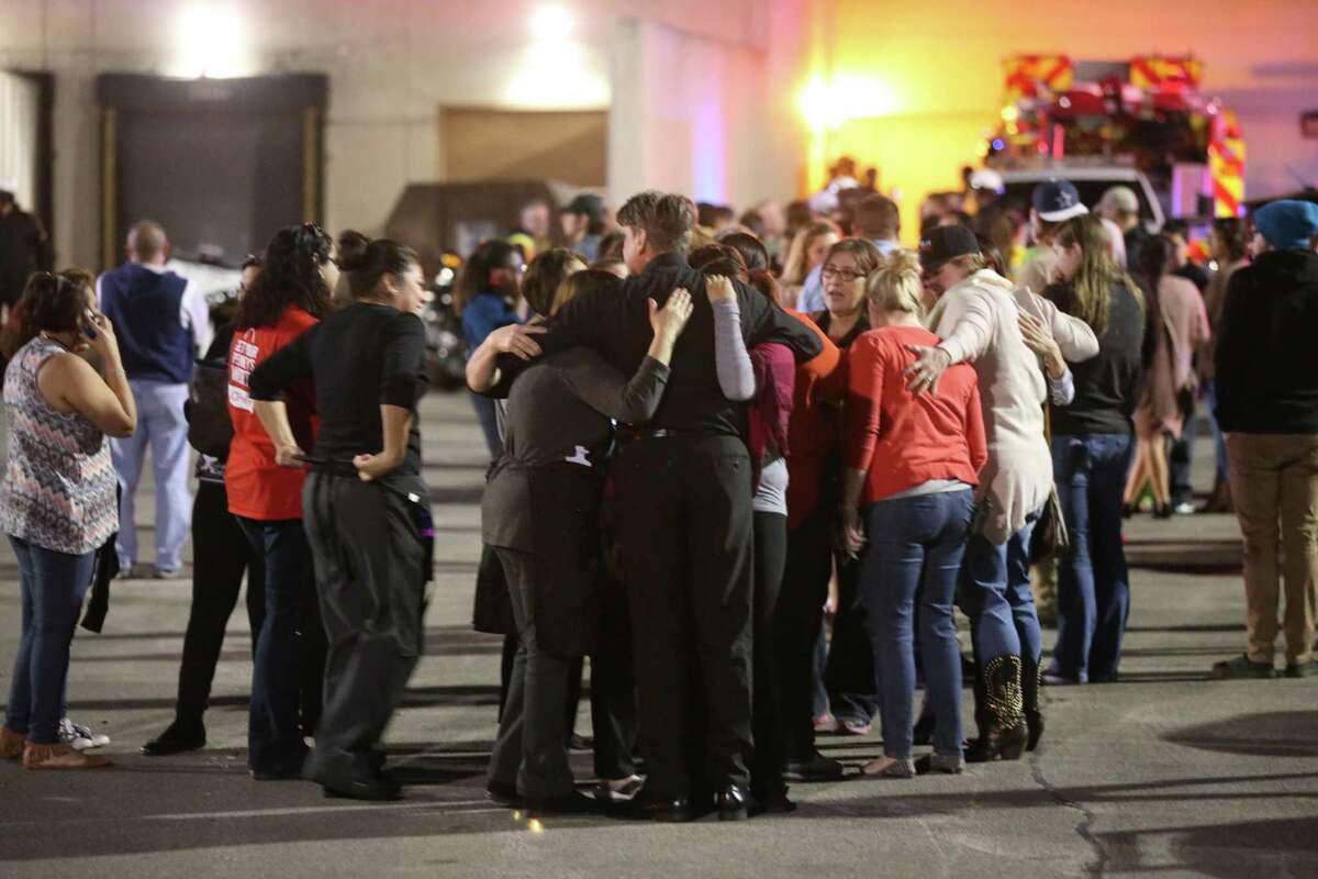 Employees and shoppers are released as law enforcement personnel work the scene of a shooting at Rolling Oaks Mall Sunday, Jan. 22, 2017. According to San Antonio Police Chief William McManus, two suspects attempted a jewelry store robbery and two good samaritans attempted to intervene. One of the samaritans was shot dead by one of the suspects. One of the suspects got away shooting six people inside the mall.