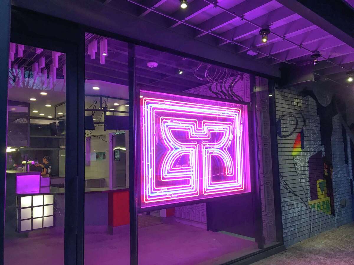 The Rice Box Heights entrance with its double-face neon logo in Blade Runner style.