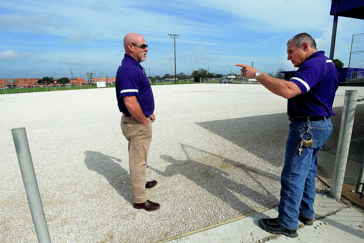 Port Neches - Groves' district Maintenance Director Jeff Bergeron (right) talks with Superintendent Dr. Rodney Cavness as they take a look at the prepped softball field. Construction crews are continuing work on laying astroturf on the baseball and softball fields at Port Neches - Groves' ball park. Both the softball and baseball fields are being renovated to have turf on field. Though heavy rainfall last month delayed the work, the projects are expected to be completed in time for season opening scrimmages within the next two weeks. The district's maintenance department have been joining in the work, allowing them to save enough money to make additional updates, including needed repairs to the masonry surrounding the field and in the dugouts, and new fencing and score boards will be in place ahead of schedule, as well. The dual-field project entailed 4500 tons of large rock, 220 tons of small rocks, and 70 massive rolls of astroturf. Photo taken Friday, January 20, 2017 Kim Brent/The Enterprise