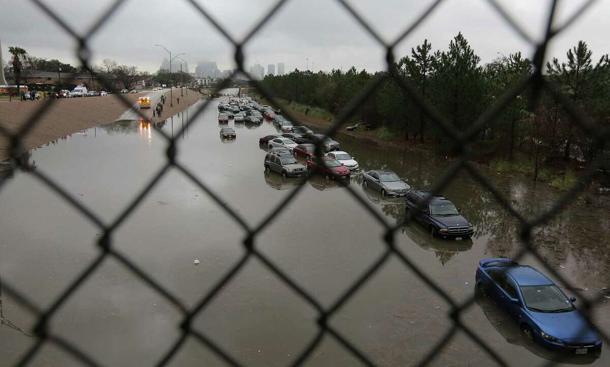 Abandoned cars on 288 near Calumet stuck in flooding from the bayou after heavy nightfall rain on Wednesday, Jan. 18, 2017, in Houston. ( Elizabeth Conley / Houston Chronicle )