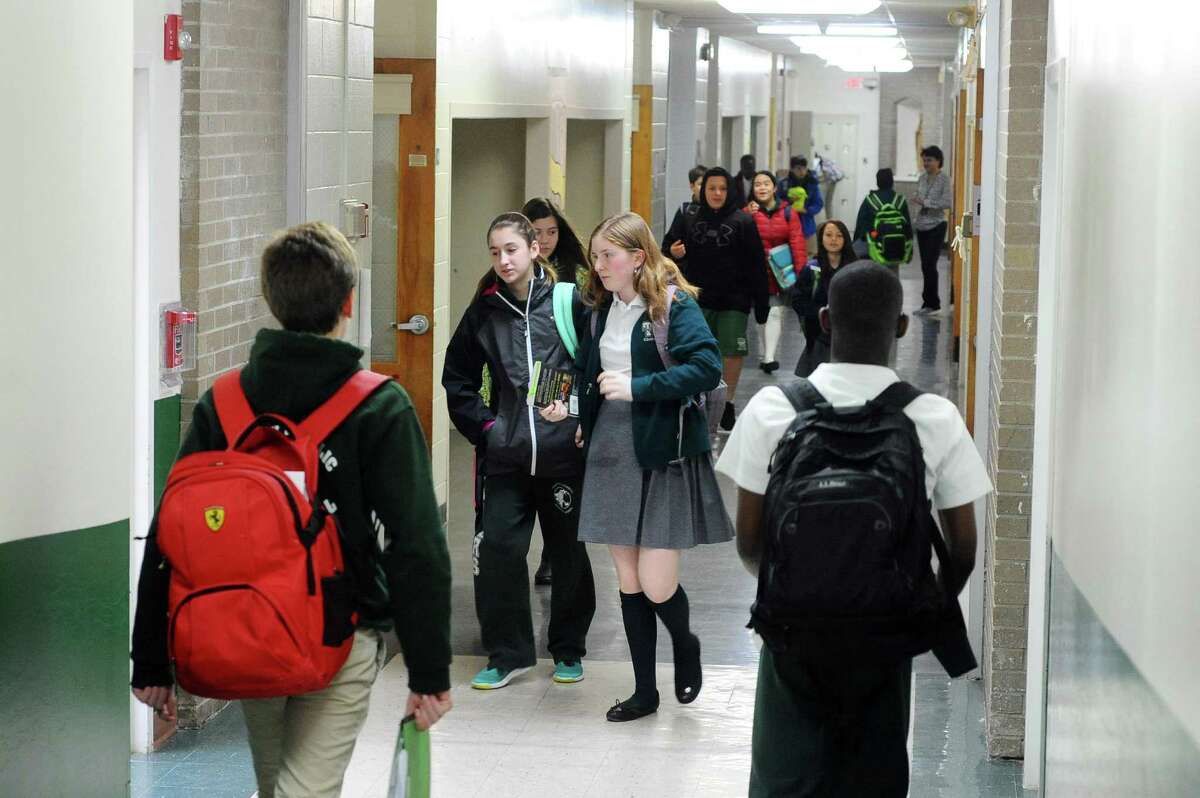 Students crowd the hallways of Trinity Catholic Middle School in Stamford, Conn. on Monday, Jan. 23, 2017.