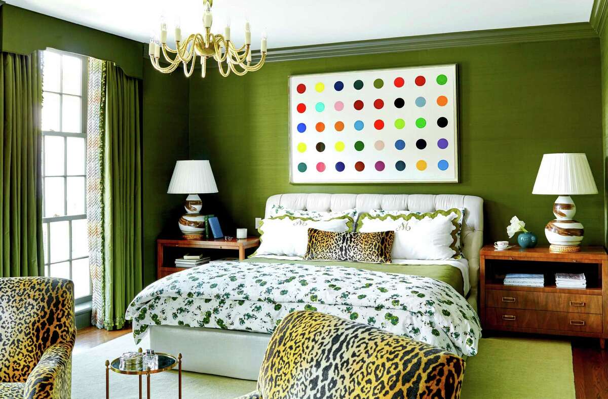 Dark green paint adds depth and personality to the master bedroom in the Houston home of Bailey McCarthy. Her home is featured in the new edition of House Beautiful magazine.
