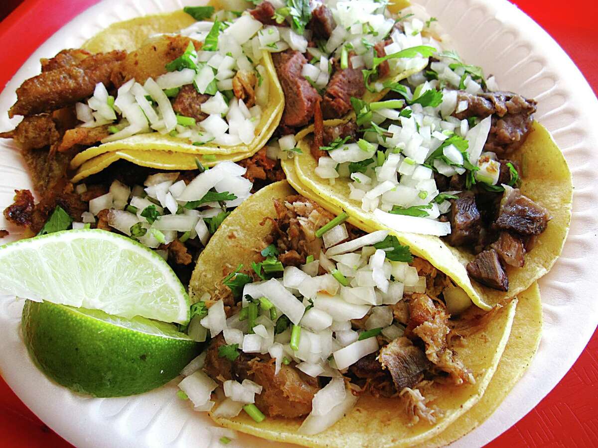 A plate of five tacos from Tacos Y Burritos Metro Basilica 2. The shop specializes in the mini-tacos of Mexico City.