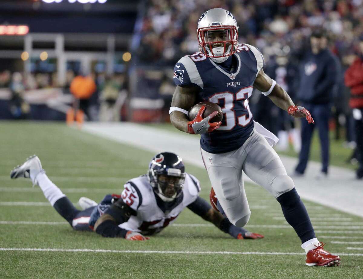 FILE - In this Jan. 14, 2017, file photo, New England Patriots running back Dion Lewis (33) runs past Houston Texans linebacker Benardrick McKinney (55) for a touchdown during the first half of an NFL divisional playoff football game in Foxborough, Mass. In last week's 34-16 win over Houston, Lewis became the first player in the Super Bowl era to score on a run, a catch and a kick return in a postseason game. (AP Photo/Steven Senne, File) ORG XMIT: NY179 ORG XMIT: MER2017011915163458