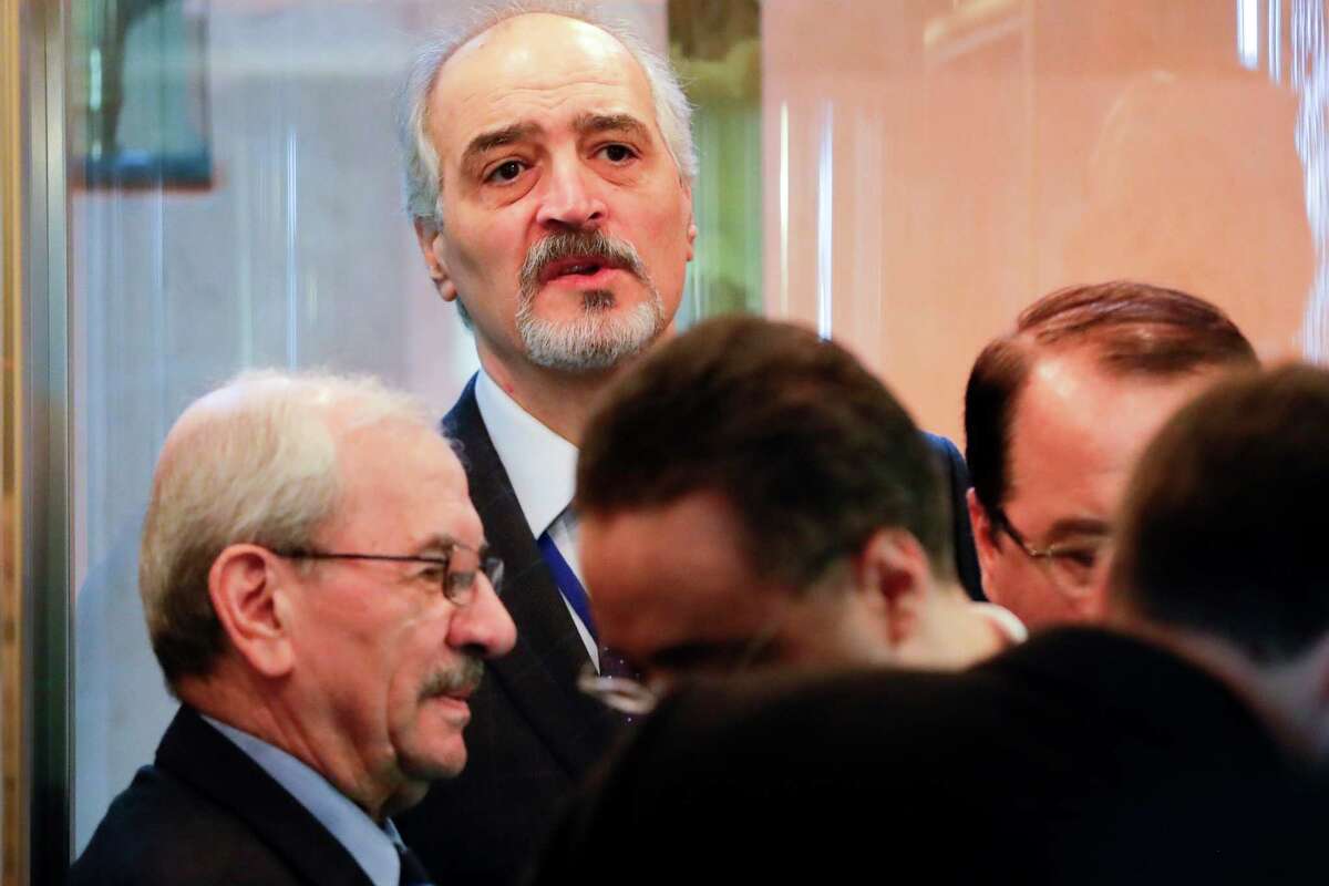 Bashar Jaafari, top, Syrian ambassador to the U.N. and head of a Syrian delegation, prepares to attend talks on Syrian peace at a hotel in Astana, Kazakhstan, Monday, Jan. 23, 2017. The talks are the latest attempt to forge a political settlement to end a war that has by most estimates killed more than 400,000 people since March 2011 and displaced more than half the country's population. (AP Photo/Sergei Grits)