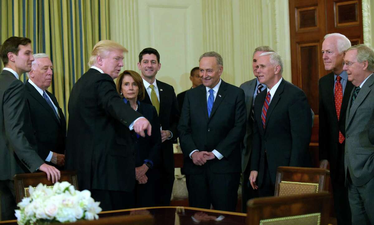 President Donald Trump, third from left, speaks during a reception for House and Senate leaders in the the State Dining Room of the White House in Washington, Monday, Jan. 23, 2017. He is surrounded by, from left, adviser Jared Kushner, House Minority Whip Steny Hoyer, D-Md., House Minority Leader Nancy Pelosi of Calif., House Speaker Paul Ryan of Wis., Senate Minority Leader Charles Schumer, D-N.Y., House Majority Leader Kevin McCarthy of Calif., Vice President Mike Pence, Senate Majority Whip Sen. John Cornyn, R-Texas., and Senate Majority Leader Mitch McConnell of Ky.