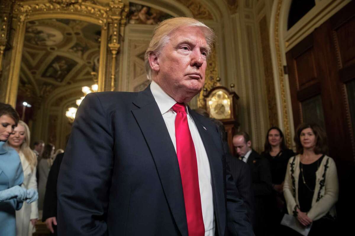FILE - In this Friday, Jan. 20, 2017, file photo, President Donald Trump leaves the President's Room of the Senate at the Capitol after he formally signed his cabinet nominations into law, in Washington. A legal watchdog group plans to file a lawsuit Monday, Jan. 23, 2017, alleging that Trump is violating the Constitution by allowing his businesses to accept payments from foreign governments. (AP Photo/J. Scott Applewhite, Pool, File)