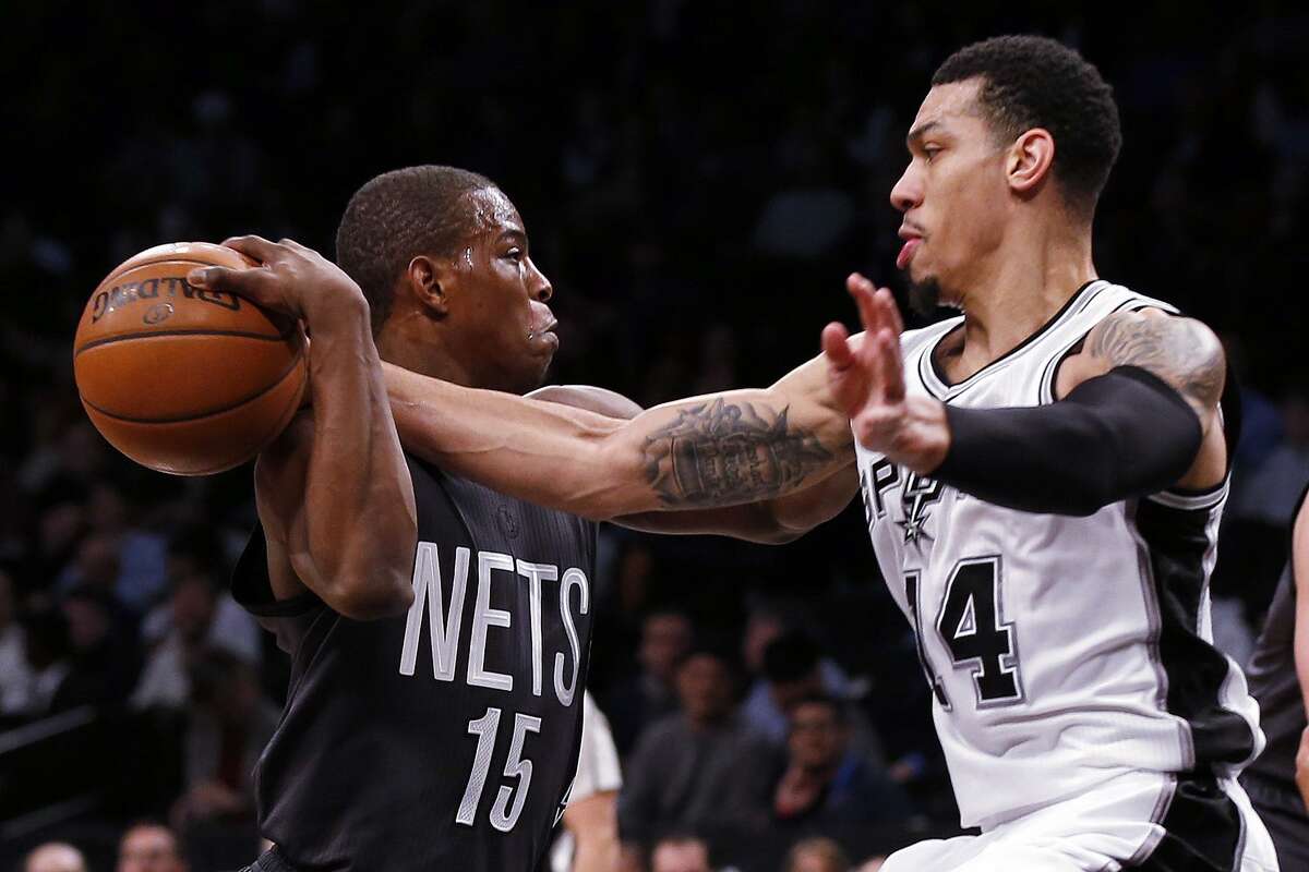 Danny Green reaches to steal the ball from Nets guard Isaiah Whitehead during the first half Monday night in Brooklyn.