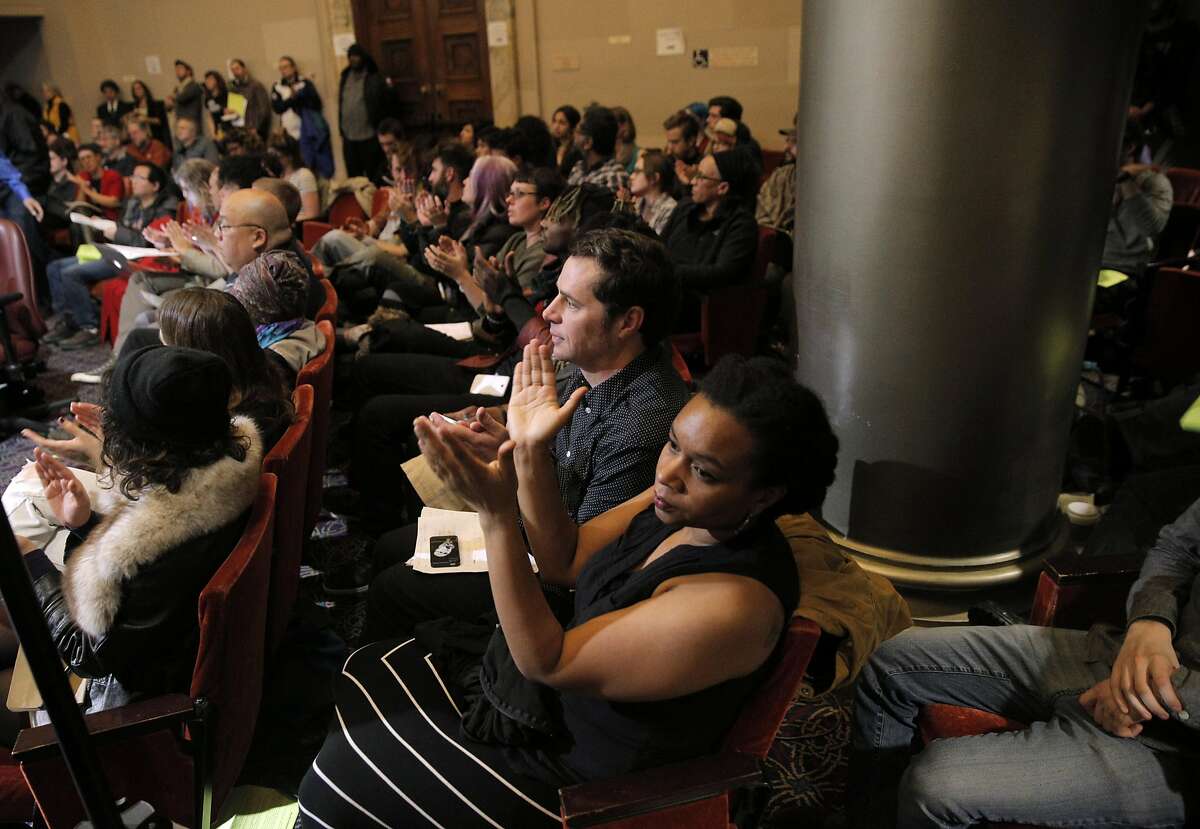 The public applauds during public comment while council discussed city measures and resolutions related to the Ghost Ship fire during a city council meeting with several at City Hall in Oakland, Calif., on Monday, January 23, 2017.