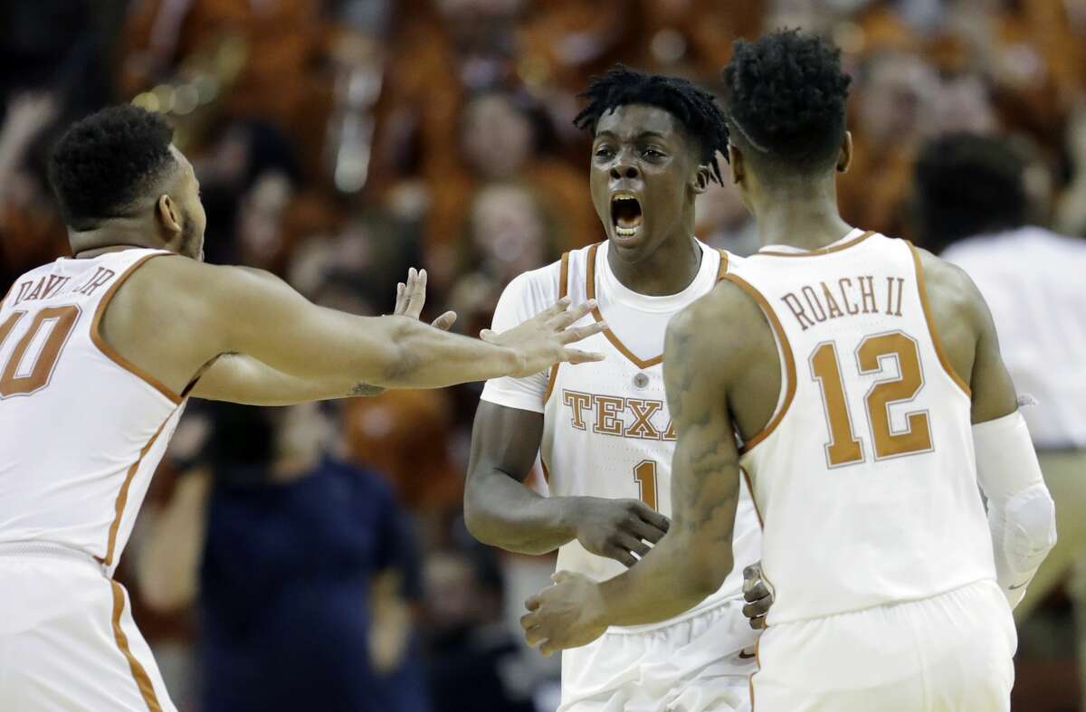 Texas guard Andrew Jones, center, celebrates with teammates Eric Davis Jr. (10) and Kerwin Roach Jr. (12) after he hit the winning shot against Oklahoma in the second half of an NCAA college basketball game, Monday, Jan. 23, 2017, in Austin, Texas. Texas won 84-83. (AP Photo/Eric Gay)