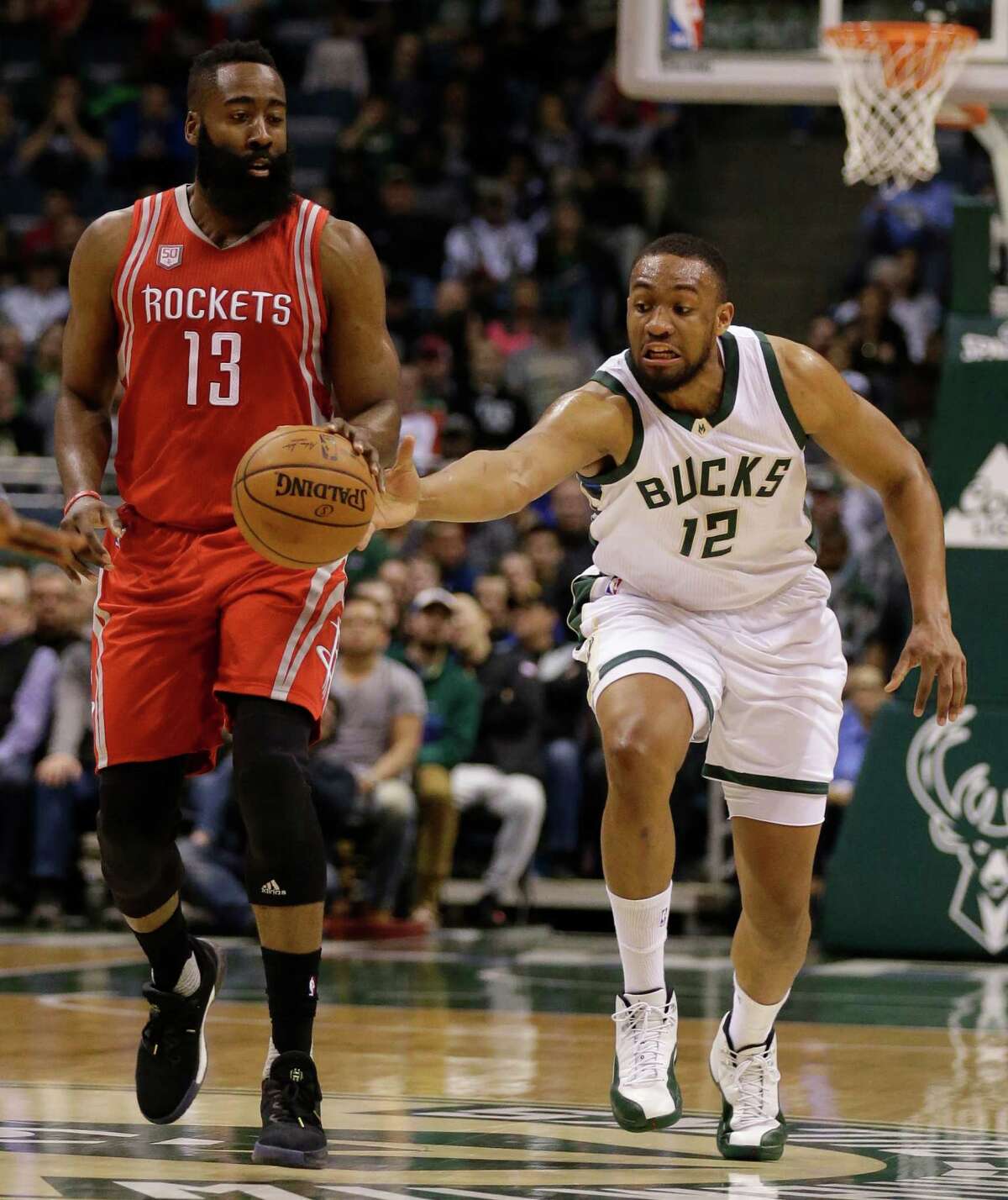 The Bucks' Jabari Parker, right, sneaks in for a steal that accounts for one of James Harden's 11 turnovers on a night the Rockets totaled 21.