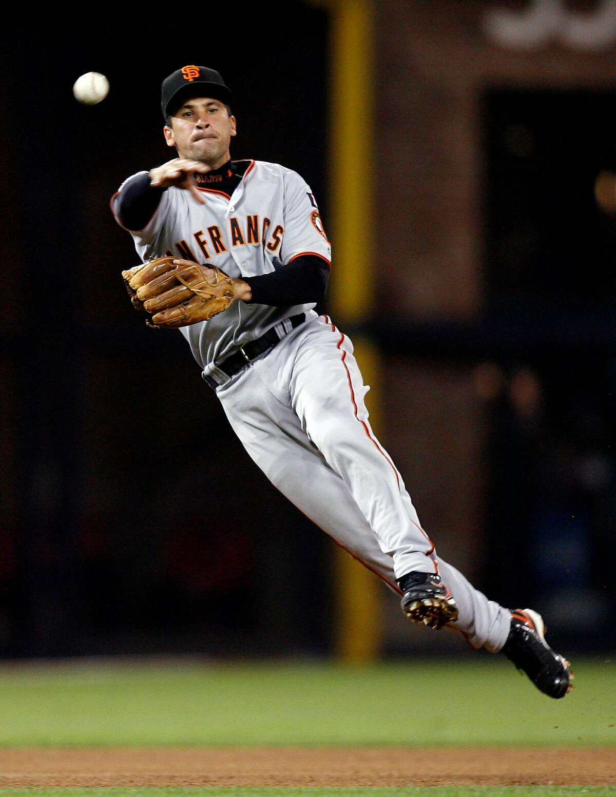 ** FILE ** In this file photo from Sept. 15, 2007, San Francisco Giants shortstop Omar Vizquel makes a leaping throw to first base to get the out on San Diego Padres' Terrmel Sledge during the sixth inning of a baseball game in San Diego. Vizquel should expect quite a homecoming Tuesday June 24, 2008 when the Indians host his San Francisco Giants in the opener of a three-game series. The 11-time Gold Glove winner, who broke Luis Aparicio's major league record for most games played at SS on May 30, returns to Cleveland for the first time since signing with the Giants as a free agent on Nov. 16, 2004. (AP Photo/Denis Poroy, file)