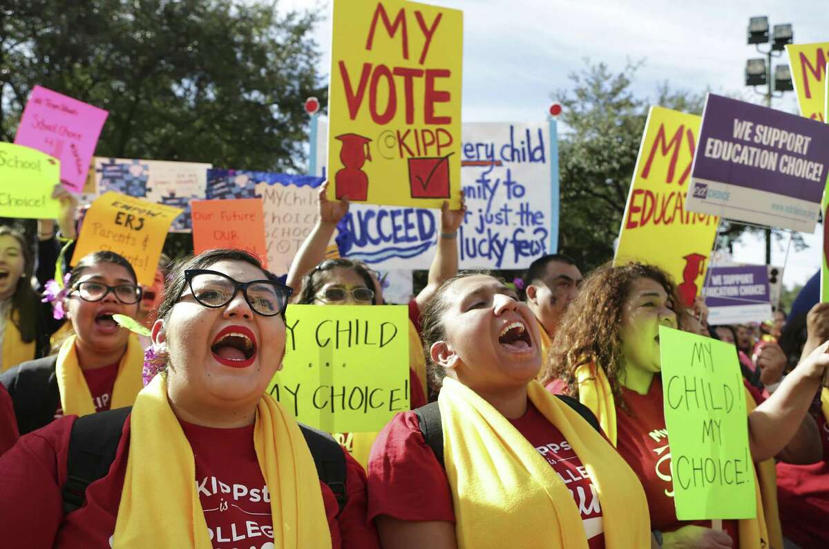 Edith Gonzalez, left, and Gloria Aguilere of KIPP Houston Public schools, yell during a cheer at the Texas Coalition School Choice Rally in front of the Texas State Capitol, commemorating National School Choice Week on Tuesday, Jan. 24, 2017, in Austin, Texas.