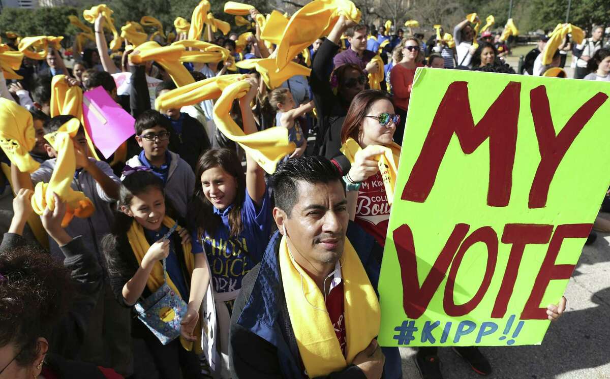 Victor Hugo Ruedas, right, of Houston, shows his support for the KIPP school system at the Texas Coalition School Choice Rally in front of the Texas State Capitol, commemorating National School Choice Week on Tuesday, Jan. 24, 2017, in Austin, Texas.