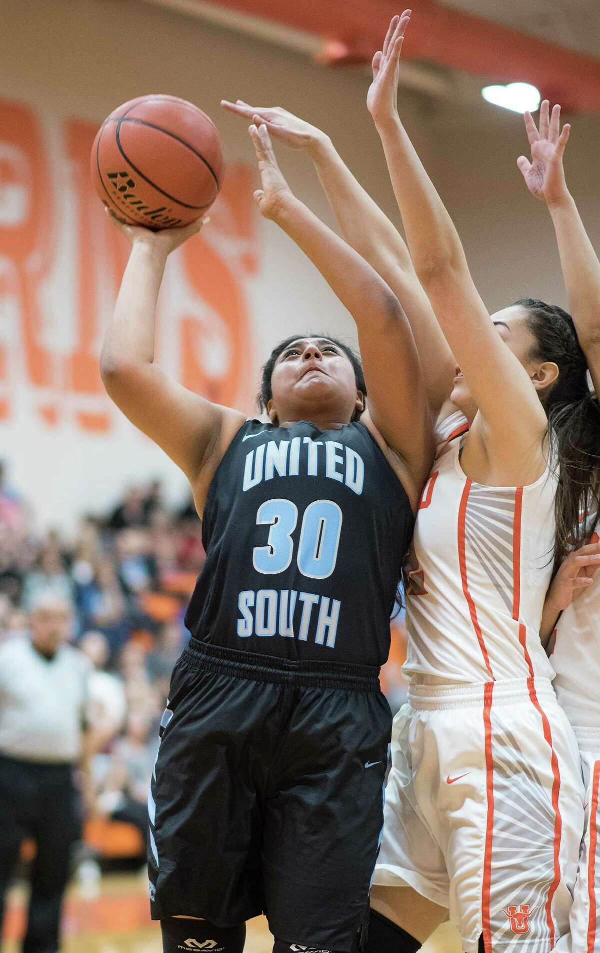 United South High School Evelyn Cruz shoots the ball as she is guarded by the United High School defense on Tuesday, January 24, 2017 at United High School.