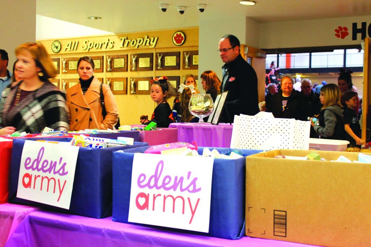 Boxes of toiletries donated for Eden's Army sit in the Edwardsville High School Commons as spectators file out of the gym after the Jan. 17 Edwardsville Cheer Showcase.