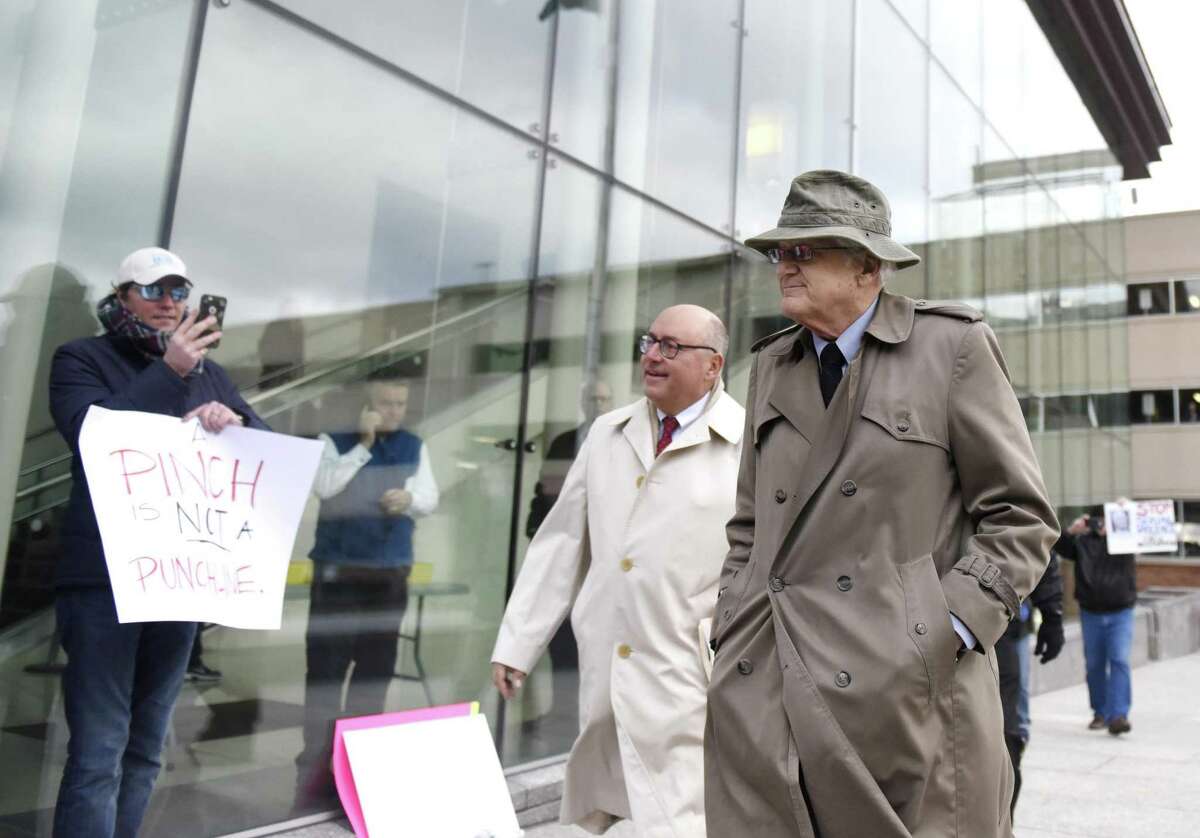 Greenwich Representative Town Meeting member Chris von Keyserling, right, and his attorney, Phil Russell, enter state Superior Court in Stamford on Wednesday as the Center for Sexual Assault Crisis Counseling and Education and community activists protest.