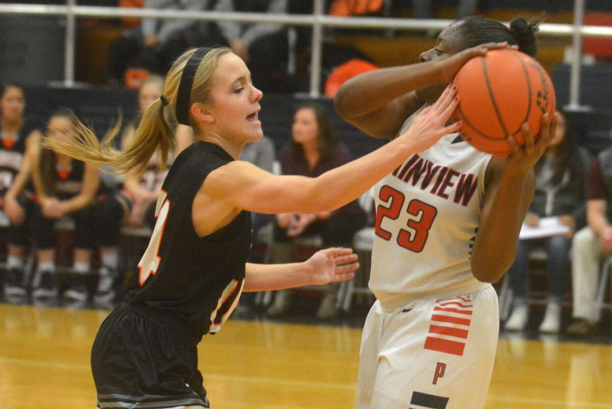 Plainview point guard Jade Nails, right, protects the ball from a Dumas defender during a game earlier this season. Nails had nine points, including two critical free throws in the final minute, to help the Lady Bulldogs to a win at Dumas Tuesday night.