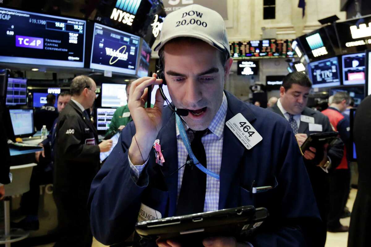 Trader Gregory Rowe wears a Dow 20,000 cap as he works on the floor of the New York Stock Exchange, Wednesday, Jan. 25, 2017. The Dow Jones industrial average is trading over 20,000 points for the first time, the latest milestone in a record-setting drive for the stock market. The market has been marching steadily higher since bottoming out in March 2009 in the aftermath of the financial crisis. (AP Photo/Richard Drew)