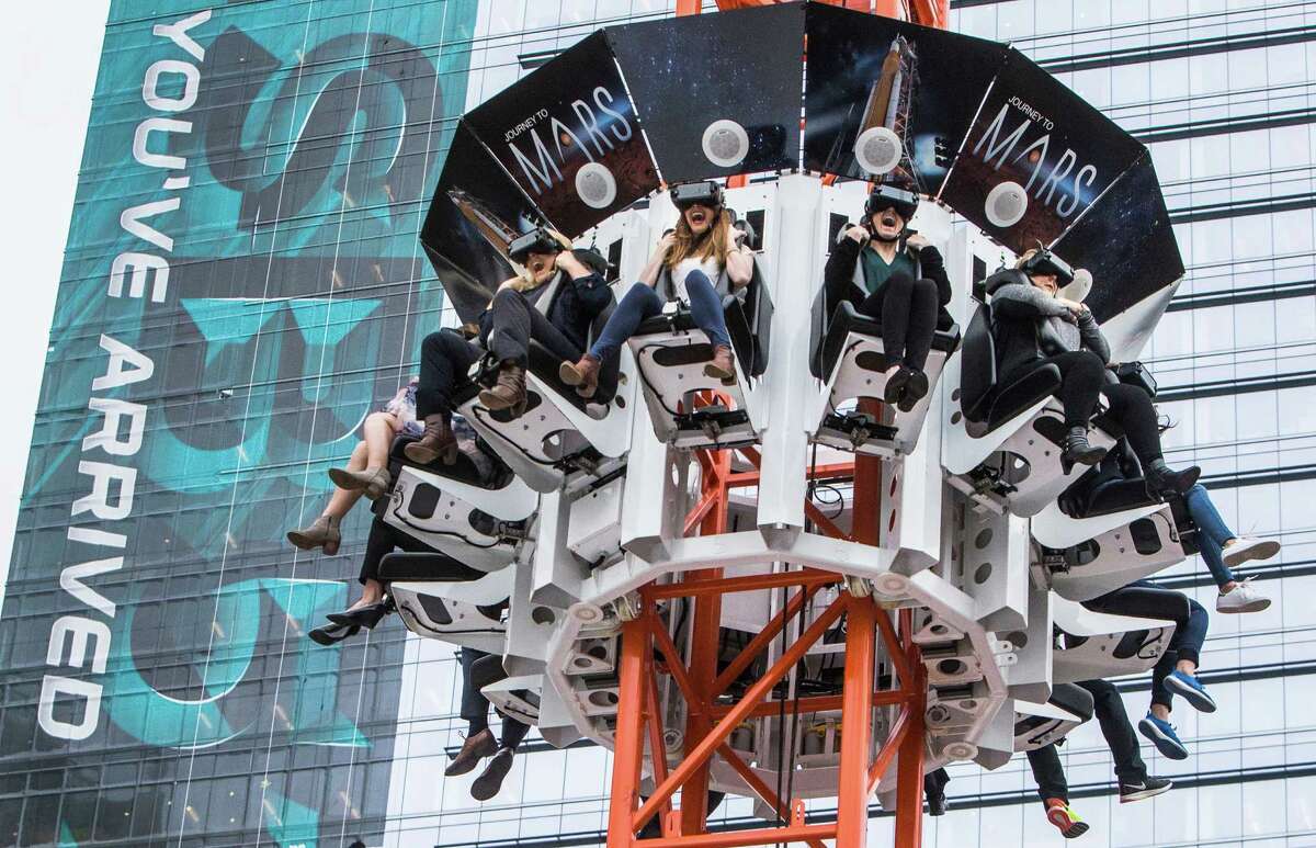 People free fall as they ride the Journey To Mars, virtual reality ride at Discovery Green on Wednesday, Jan. 25, 2017, in Houston. The so-called Super Bowl Live "Wow Factor" is a free drop-tower, that has people wear virtual reality goggles, ride to the top and free fall, getting the a virtual sensation of a journey to Mars and back. ( Brett Coomer / Houston Chronicle )