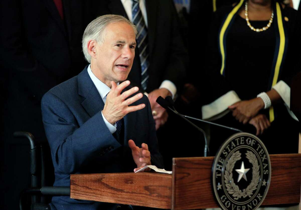 FILE - In this Friday, July 8, 2016 file photo, Texas Gov. Greg Abbott, right, responds to questions during a news conference at City Hall in Dallas. Abbott says he'll work with top conservatives to try to remove from office sheriffs across his state who refuse to enforce federal immigration law. It's the latest sign that Abbott is moving hard to the right and more closely tracking the new Trump administration, which is plotting ways to crackdown on immigration. (AP Photo/Tony Gutierrez, File)
