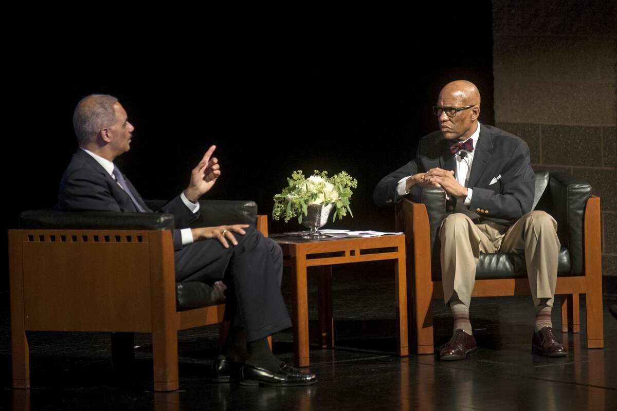 Former U.S. Attorney General Eric Holder, left, speaks with Saginaw's Chief Judge Terry L. Clark of the 70th Judicial District Court during the Eighth Annual Great Lakes Bay Regional MLK Jr. Celebration on Wednesday at Saginaw Valley State University's Malcolm Field Theatre for Performing Arts. Holder served as the first African-American Attorney General from 2009 to 2015. Holder talked about his upbringing, his time in the White House and more. As Holder recalls, when President Obama called to offer him the position, he ended the call with "Let's go make some history."