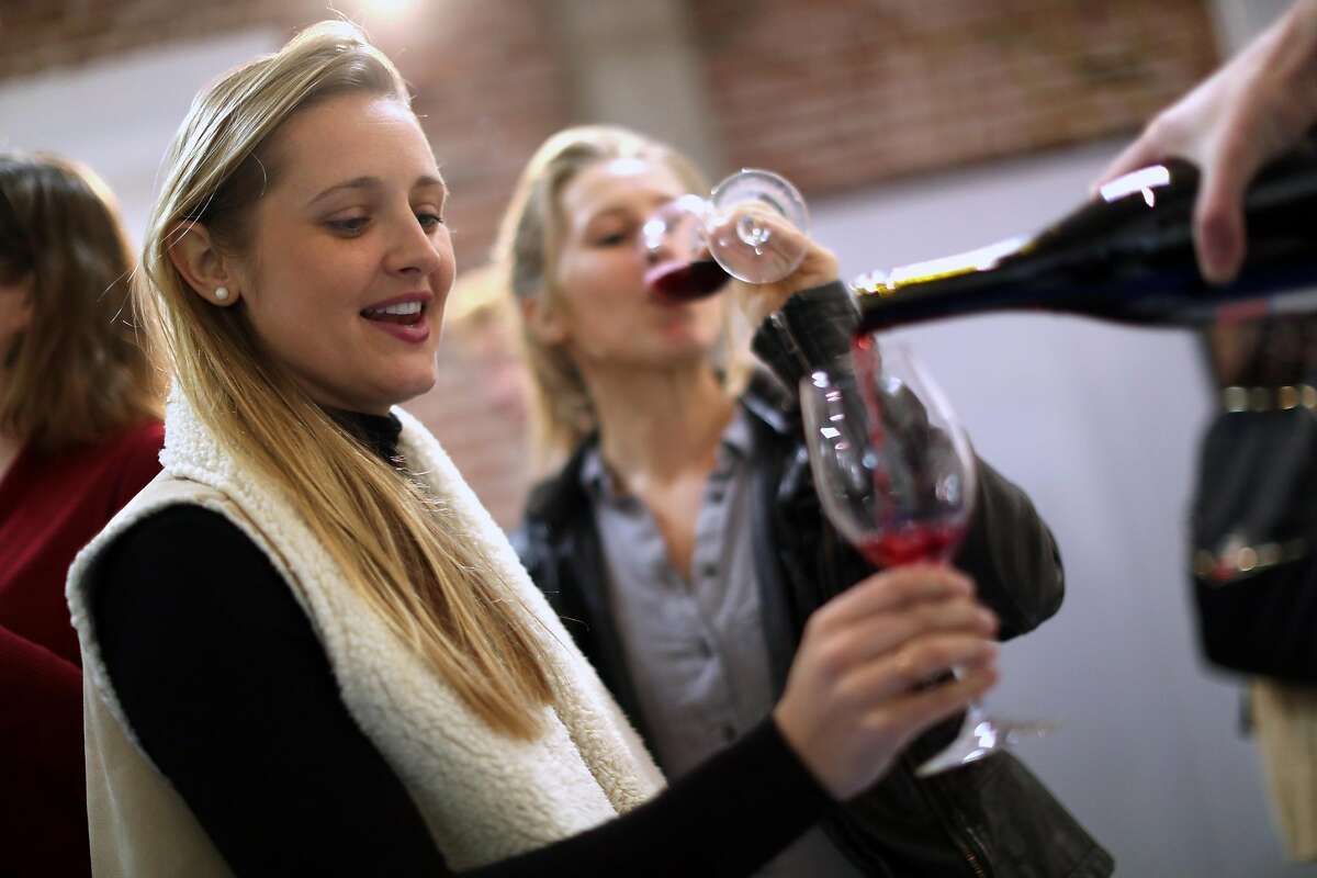 Sisters Alexa and Kylie Wagner enjoy Foot of the Bed Cellars' wine club pick up party in San Francisco, Calif., on Wednesday, January 25, 2017.