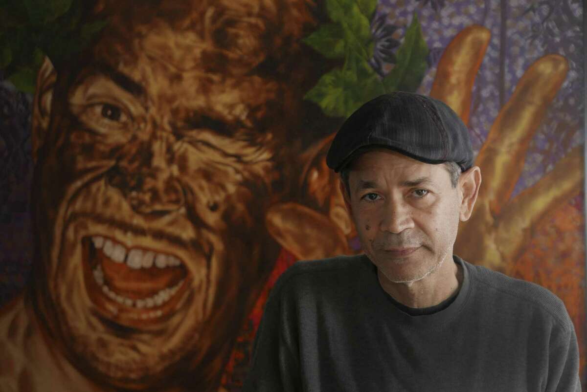 Artist Angel Rodriguez-Diaz at home in San Antonio. The artist, known for his self-portraits, stands before a work titled “The Good Old Days.”