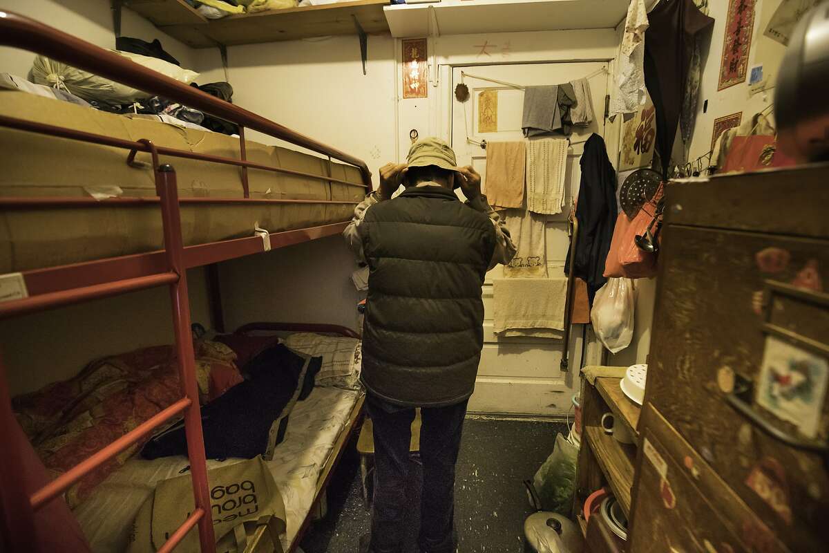 Jin Nuan Huang, 76, puts on his at in his room at 937 Clay Street on Thursday, Jan. 26, 2017 in San Francisco, Calif. He is a plaintiff in the lawsuit. Chinatown Community Development Center is alleging that the owner of a Chinatown CDC (SRO) is harassing long-time residents -- hoping to get them to leave in order to replace them with high rent paying tech workers and students.