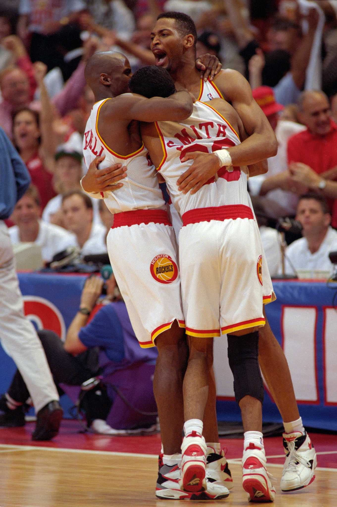 The New York Knicks Patrick Ewing, left, goes over the heads of the Houston  Rockets Hakeem Olajuwon (34), Otis Thorpe (33) and the Knicks Charles Oakley  during the third quarter of Game