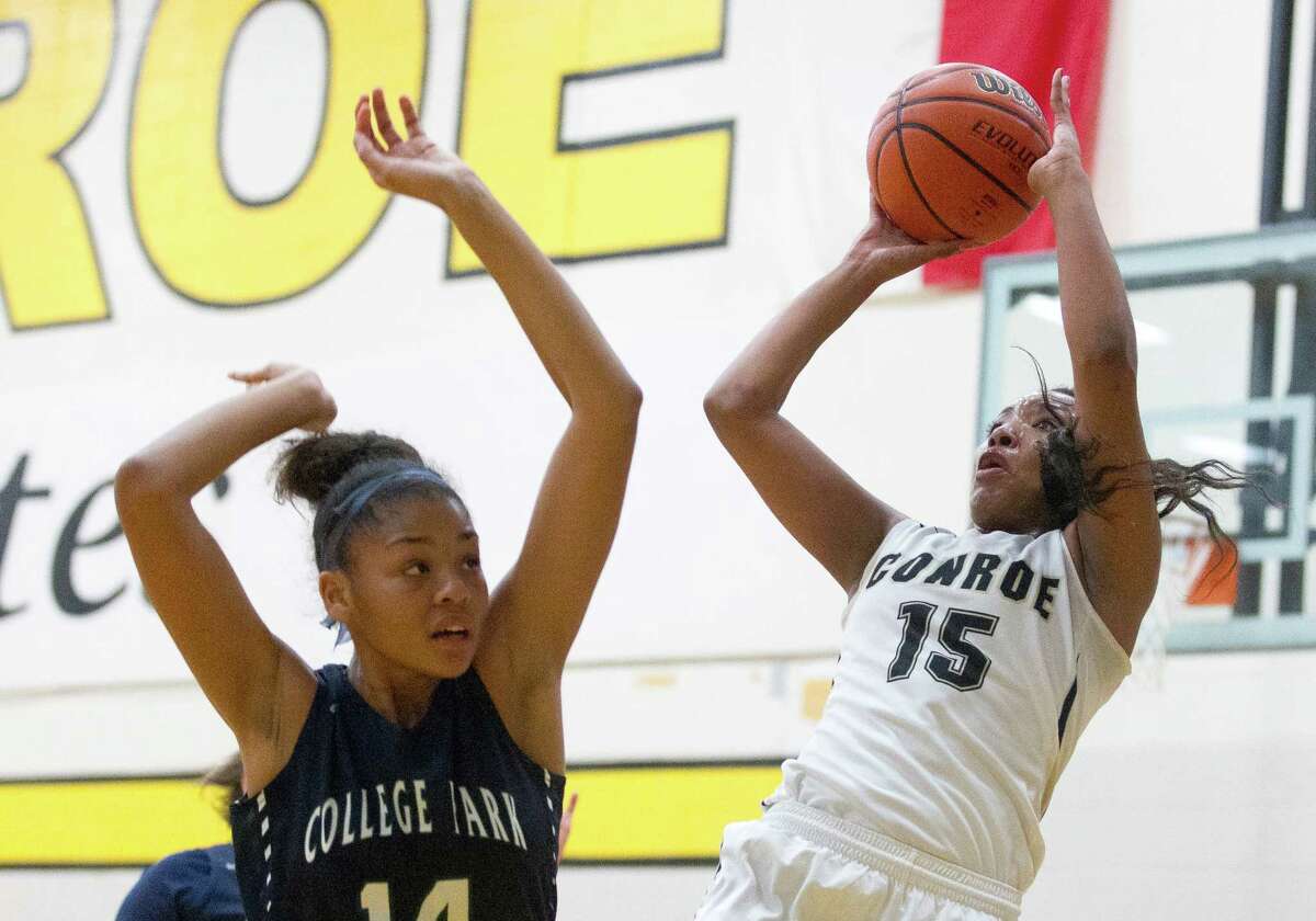 Conroe center Victoria Ratcliff (15) shoots over College Park center Sandra Cannady (14) during the second quarter of a District 16-6A high school girls basketball game at Conroe High School Tuesday, Jan. 10, 2017, in Conroe. College Park defeated Conroe 59-50.