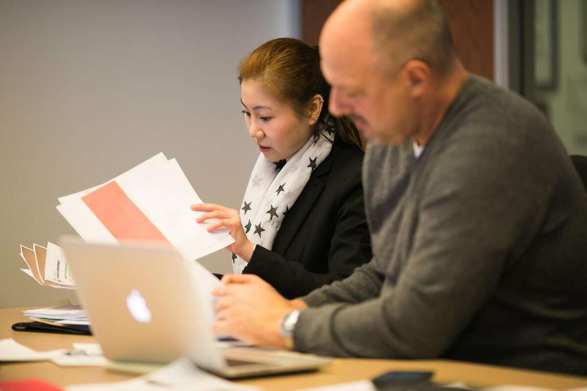 Alice Tse goes through documents with her lawyer, Steve Whitworth, during an administrative hearing at San Francisco’s Office of Short-Term Rentals.