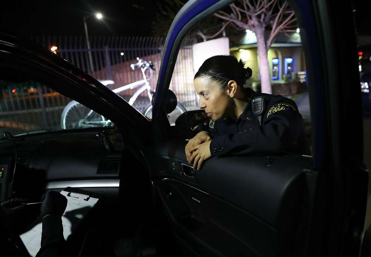 San Jose Police Department Lt. Elle Washburn confers with fellow officers in San Jose, Calif., on Tuesday, January 24, 2017. Due to police short staffing, Lt. Washburn has returned to patrols for the first time in 4 years.