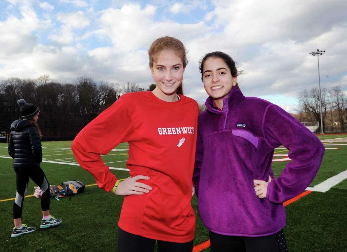 Greenwich girls track team members, Lia Zavattaro, left, a pole vaulter, and Emily Philippides, a middle distance runner, during practice at the Cardinal Stadium track at Greenwich High School on Thursday.