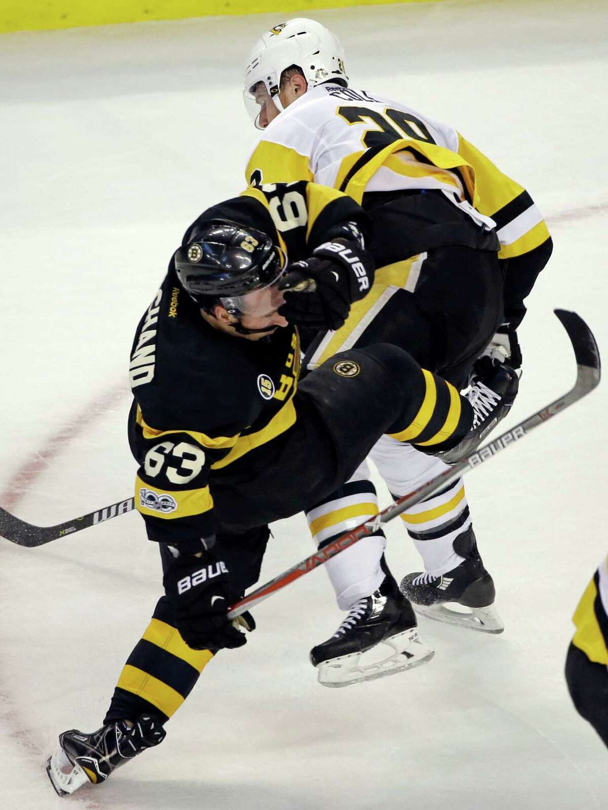 Pittsburgh Penguins defenseman Ian Cole (28) collides with Boston Bruins left wing Brad Marchand (63) during the first period of an NHL hockey game, Thursday, Jan. 26, 2017, in Boston. (AP Photo/Elise Amendola) ORG XMIT: MAEA103