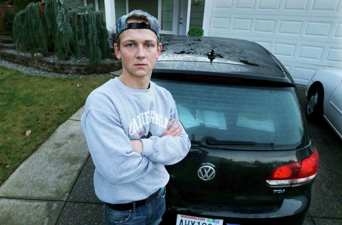 In this Jan. 24, 2017, photo, David Derkach poses for a photo with his Volkswagen Golf, at his home in Federal Way, Wash. Derkach has faced delays in getting Volkswagen to buy back his diesel-engine vehicle following VW's emissions-cheating scandal. 