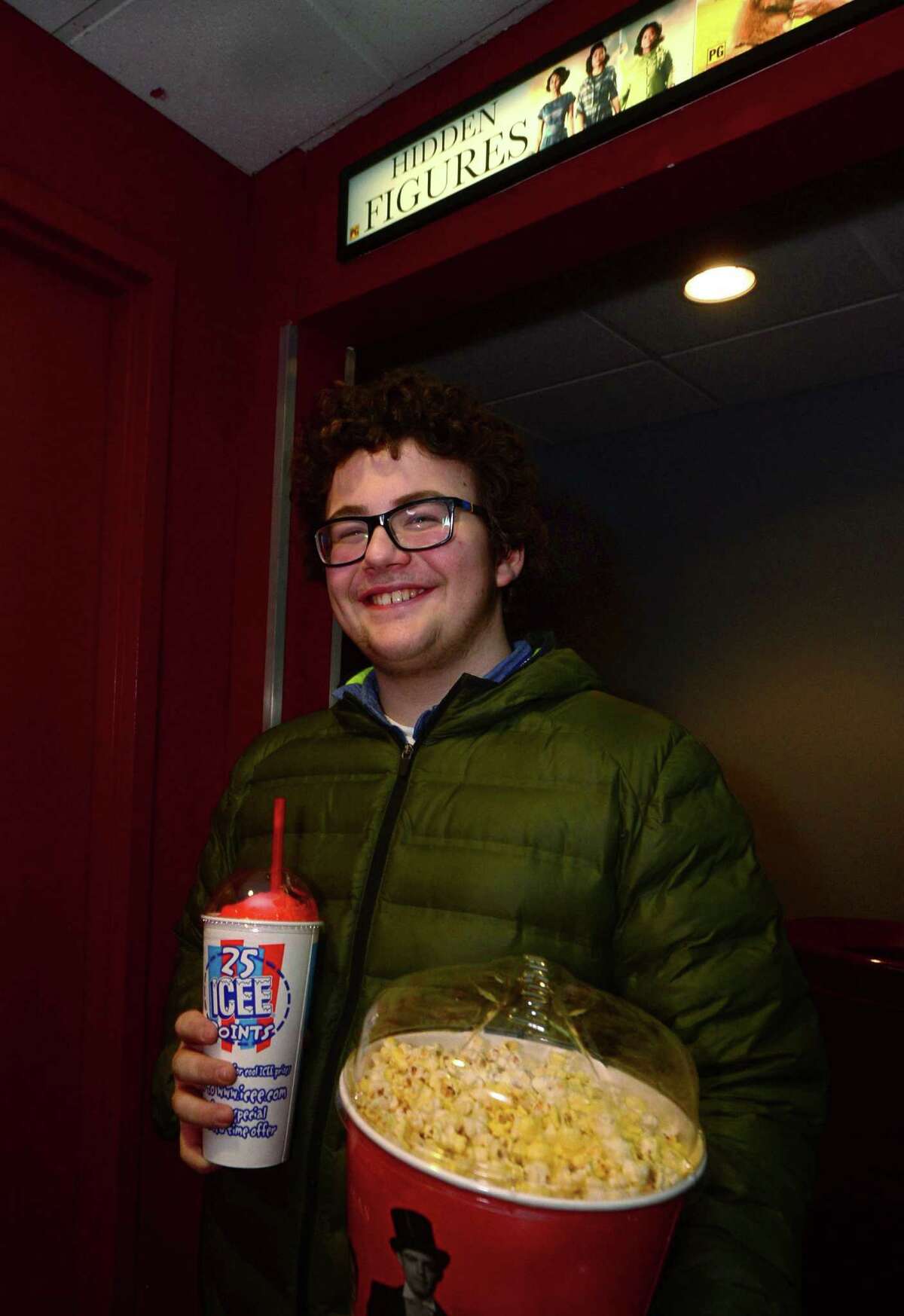 Eighth grader Donny Defala is prepared with popcorn and a drink as a group of nearly 200 students and more than 20 adults from Nathan Hale Middle School take a trip to the movies Friday morning, January 27, 2017, for a special screening of ?“Hidden Figures?”, a movie that has drawn critical acclaim for its depiction of the African-American mathematicians who provided NASA with important data needed to launch the program's first successful space missions, at the Bow Tie Regen in South Norwalk, Conn. The trip was originally going to be used as an incentive to students, but after further reflection of ?“the importance of the subject matter and message,?” school officials decided that the entire eighth grade should have the opportunity to see the film.