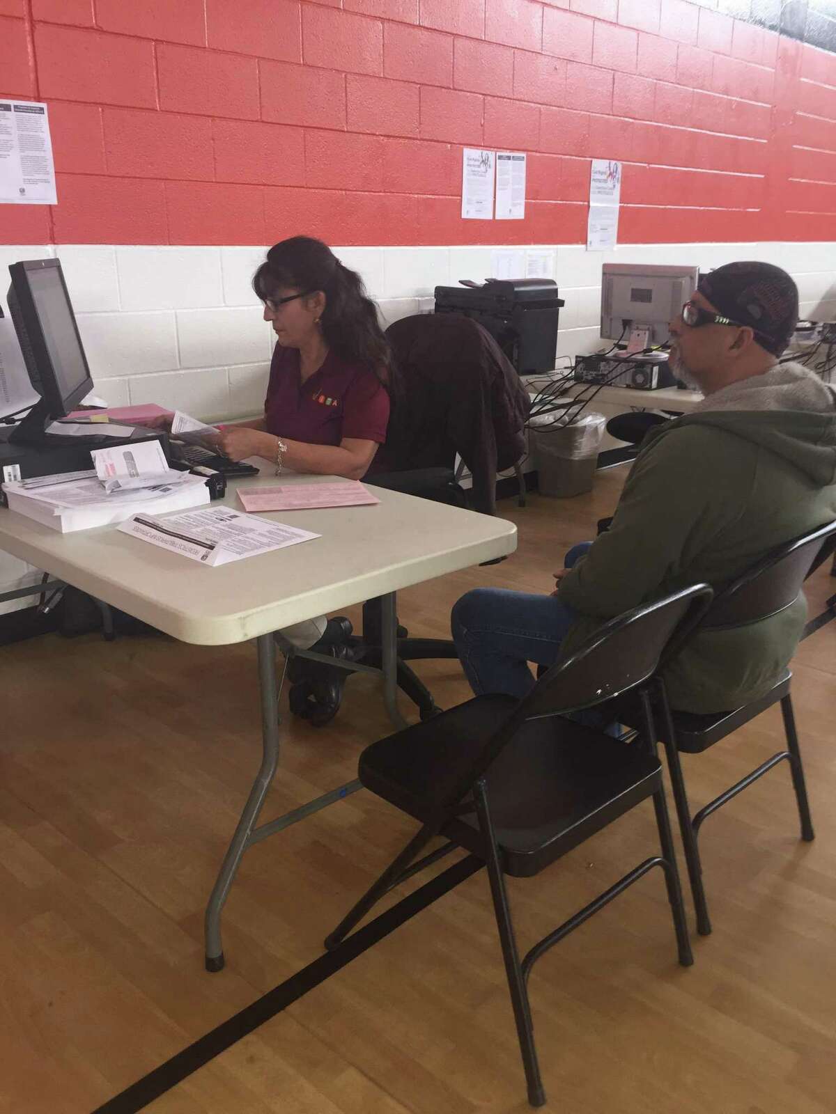 Volunteer Income Tax Assistance volunteer Alma Lopez processes an income tax filing Friday for taxpayer Mario Pina at the YWCA on Castroville Road.