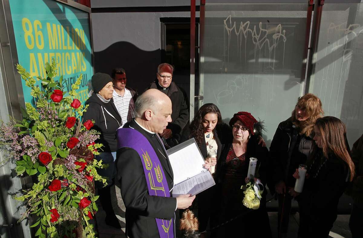 The Archbishop of San Francisco Salvatore Cordileone leads a prayer service on the corner of O' Farrell and Larkin streets, for Gabriel Ramirez, joined by Alma Zamora the Restorative Justice Community Organizer for the Archdiocese of San Francisco (center left) and the girlfriend of the victim Grainne O'Brien (right center red hat) in San Francisco, Ca., on Friday Jan. 27, 2017. Ramirez, 61 years old, was beaten and killed in the Tenderloin on January 5th.